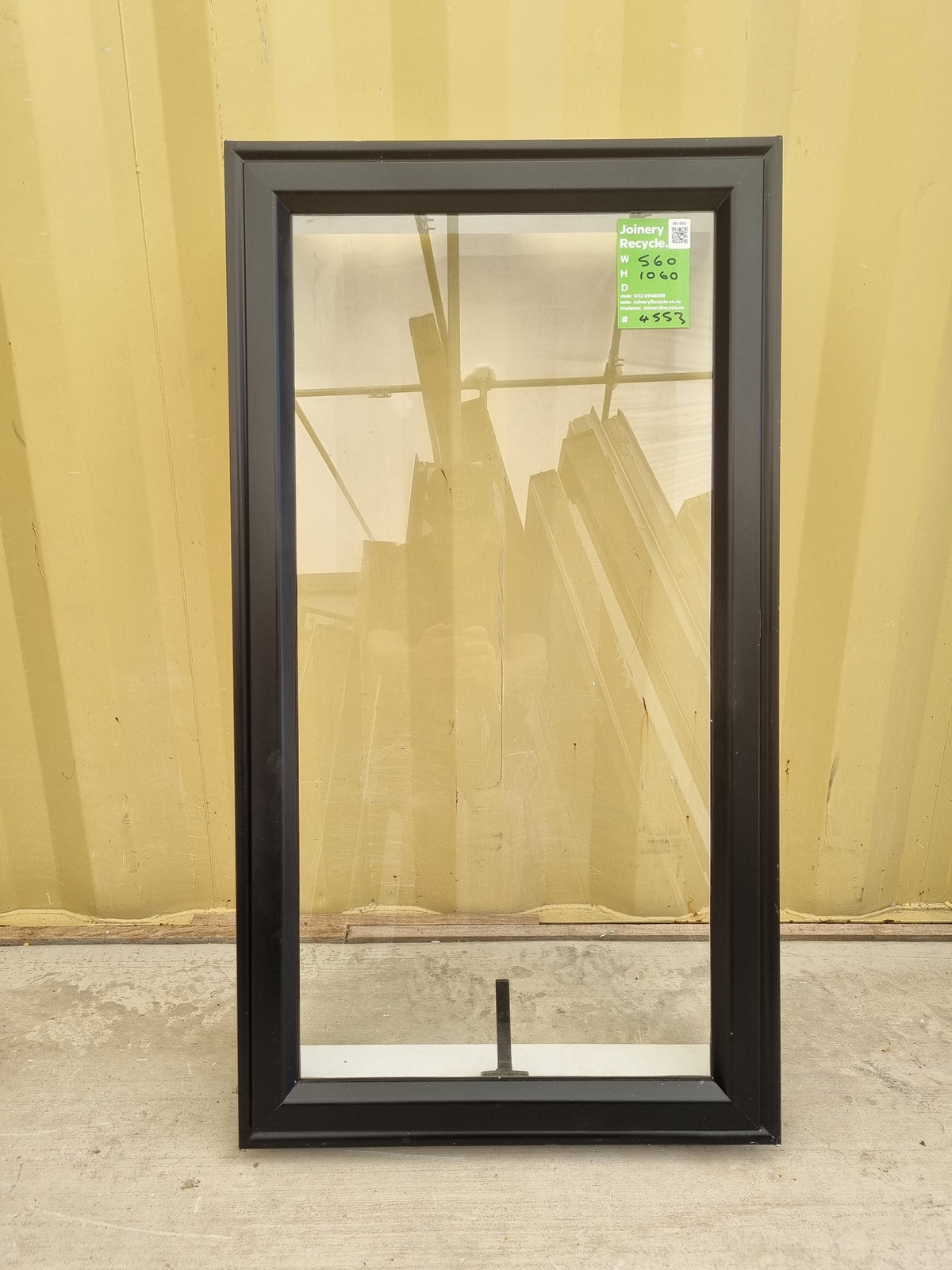 Second-hand Black Aluminium Window with an awning opening sash. Size: 560 mm Wide x 1060 mm High.