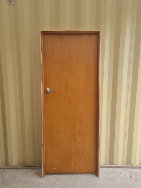 Secondhand framed rimu veneer internal door with chrome lever door handle.  Bedroom or hallway door for 1940s - 1950s Bungalow or State House