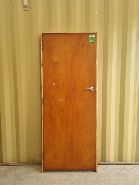 Secondhand framed rimu veneer internal door with chrome lever door handle.  Bedroom or hallway door for 1940s - 1950s Bungalow or State House