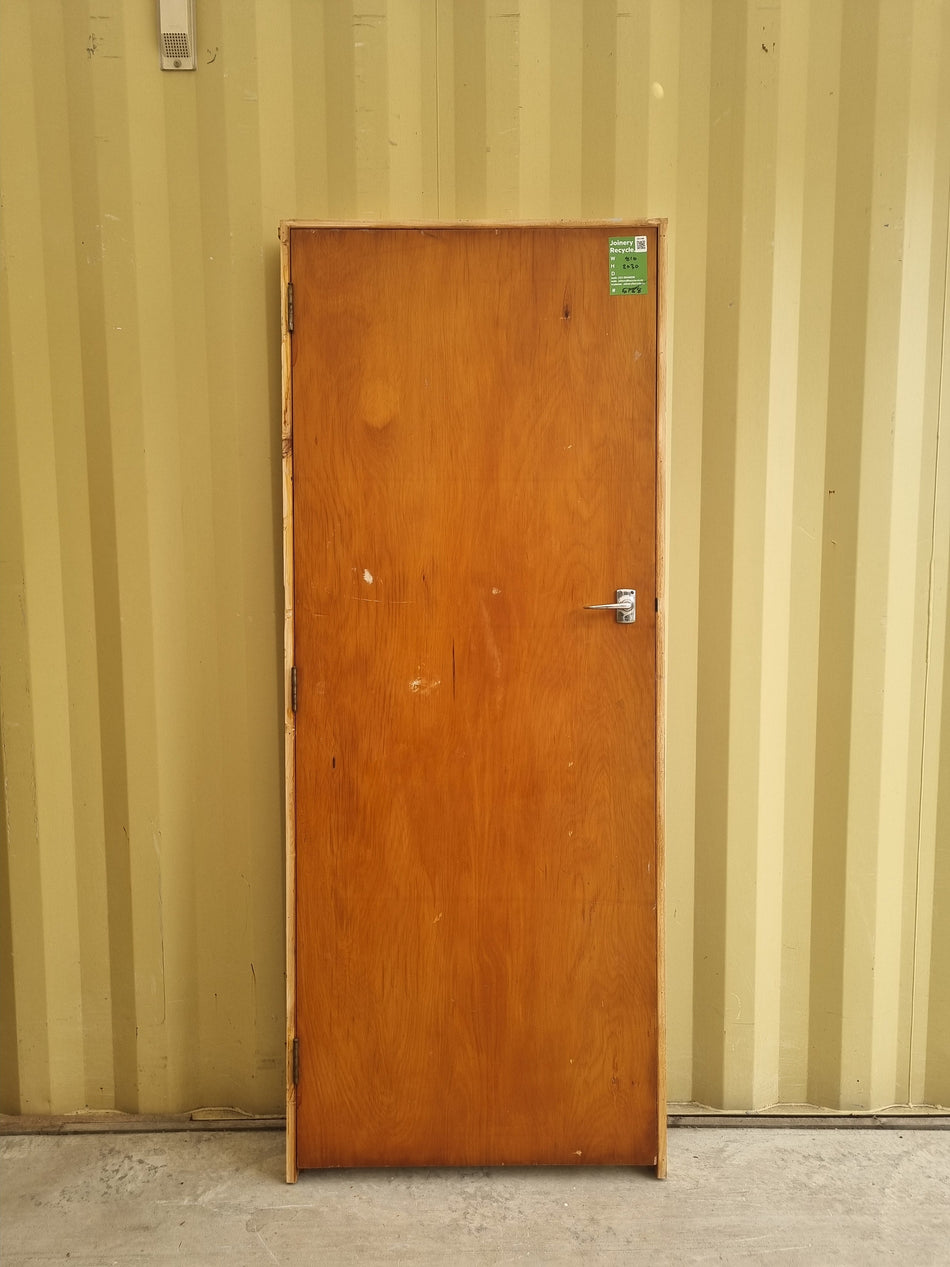 Secondhand framed rimu veneer internal door with chrome lever door handle.  Bedroom or hallway door for 1940s - 1950s Bungalow or State House